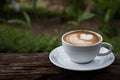 a cup of Cappuchino coffee on wooden table