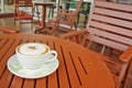 A cup of Capuchino coffee on wooden table Royalty Free Stock Photo