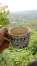 a cup of caramel machiato coffee in the morning with a view of the mountains