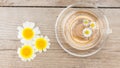 Cup of chamomile tea with chamomile on rustic wooden background. Top view. Royalty Free Stock Photo