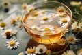 A cup of chamomile tea with a teabag and chamomile flowers floating on the surface, representing relaxation, wellness, and herbal