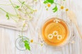 Cup of Chamomile tea on wooden kitchen table Royalty Free Stock Photo