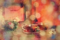 Cup with Christmas ornament near fireplace. Winter holiday concept. Cup of hot drink in front of warm fireplace. Cozy relaxed mag Royalty Free Stock Photo