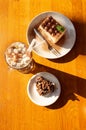 Cup of cocoa with marshmallows, a tiramisu cake and two pieces of chocolate chip cookies in a cafÃÂ© on the table. Royalty Free Stock Photo