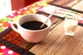 Cup of cofe and cream on bamboo mat Royalty Free Stock Photo