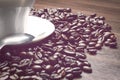 Cup of coffe alongside with coffe beans on the table alongside with spoon