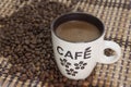 Cup of coffe on the bamboo background and coffee beans Royalty Free Stock Photo