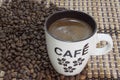 Cup of coffe on the bamboo background and coffee beans Royalty Free Stock Photo