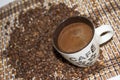 Cup of coffe on the bamboo background and coffee beans Royalty Free Stock Photo