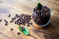 Cup of coffe beans and green leaf Royalty Free Stock Photo