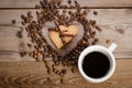 The cup of coffe and Frame-heart from coffee beans and two cookies Royalty Free Stock Photo