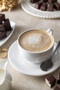 Cup of coffe with milk or cappuccino and chocolate candies, morning coffe Royalty Free Stock Photo