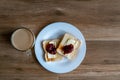 Cup of coffe with milk and two slices of toasted sandwich with Butter and Raspberry Jam. Breakfast with coffee. Top view. Free Royalty Free Stock Photo