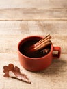Cup of coffe with space and leaf on wooden background