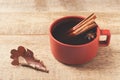 Cup of coffe with space and leaf on wooden background