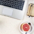 cup of coffee on the table with grapefruit and laptop Royalty Free Stock Photo
