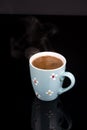Cup of coffee above black background with reflections Royalty Free Stock Photo