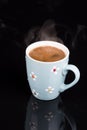 Cup of coffee above black background with reflections Royalty Free Stock Photo