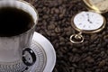 Cup of coffee against beans background closeup Royalty Free Stock Photo