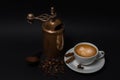 Cup of coffee, aged manual coffee grinder, coffee beans, anise, ground coffee, cinnamon sticks Royalty Free Stock Photo