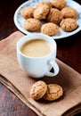 Cup of coffee with amaretti Italian biscuits on rustic wooden background. Royalty Free Stock Photo