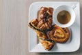 A cup of coffee with 3 assorted bakery products, flat lay Royalty Free Stock Photo