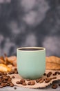 Cup of coffee with autumn leaves and rasted coffee beans Royalty Free Stock Photo