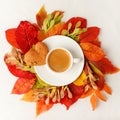 Cup of coffee and autumn leaves wreath on a white table, Seasonal warming flatlay concept of menu - cafe, coffeehouse. Bright fall