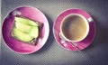 Cup of coffee and avocado sandwiich on red plates Royalty Free Stock Photo