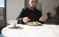 Cup of coffee in the background of a business man eating in a restaurant Royalty Free Stock Photo