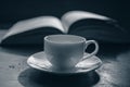 Cup of coffee on the background of an open book. Royalty Free Stock Photo