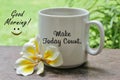 A cup of coffee with Bali frangipani flower on the wooden table with inspirational motivational quote on it - Make today count. Royalty Free Stock Photo