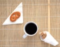 Cup of coffee on a bamboo napkin, top view