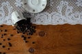 Cup of coffee, coffee bean in cup with tablecloth on the wood table. lace. White coffee cup and roasted coffee beans with rustic w Royalty Free Stock Photo