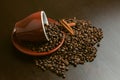 Cup of coffee with beans from above on wood background with cinnamon and sugar Royalty Free Stock Photo