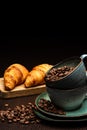 Cup with coffee beans on a black background