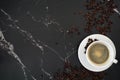 Cup of coffee with beans, with black marble background