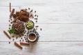 Cup of coffee, coffee beans and cardamom with ground powder on white wooden background. Royalty Free Stock Photo