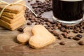 The cup of coffee, coffee beans and cookies-hearts related together Royalty Free Stock Photo