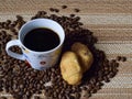 A Cup of coffee beans and croissants. Royalty Free Stock Photo