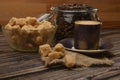 A Cup of coffee, coffee beans in a glass jar and pieces of brown sugar on a wooden background Royalty Free Stock Photo