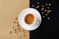 Cup of coffee and coffee beans on gold black background. Creative flat lay. Top view