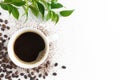 Cup of coffee, coffee beans and green leaves on white background, flat lay