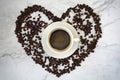 Cup of coffee with beans, heart shape, with marble background Royalty Free Stock Photo
