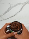 a cup of coffee beans held in two hands with copy space Royalty Free Stock Photo