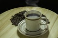 A cup of coffee with the coffee beans