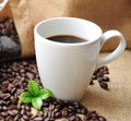 Cup of coffee with beans and leaf. Royalty Free Stock Photo