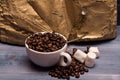 Cup of coffee beans, marshmallows and book Royalty Free Stock Photo