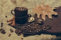 Cup with coffee beans and oak leaf Royalty Free Stock Photo