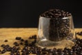 A Cup of coffee beans on old black background